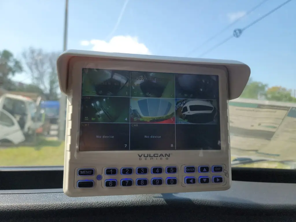 Dashboard-mounted Vulcan Series vehicle monitoring display showing multiple live camera feeds from different angles around a fleet or service vehicle, providing enhanced driver visibility, safety, and situational awareness.