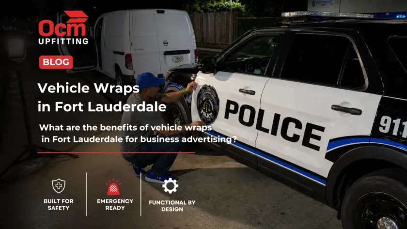 Technician applying a professional vinyl vehicle wrap on a police SUV in a well-lit outdoor setting at night