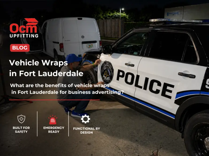Technician applying a professional vinyl vehicle wrap on a police SUV in a well-lit outdoor setting at night