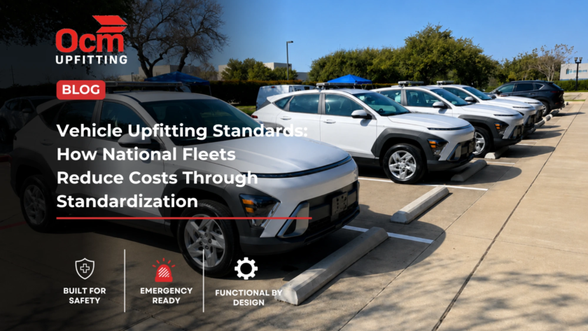 Row of white Allied Universal security fleet SUVs parked in a clean outdoor parking lot under a clear blue sky, showcasing standardized fleet vehicles equipped with roof-mounted emergency lighting and professional fleet branding.