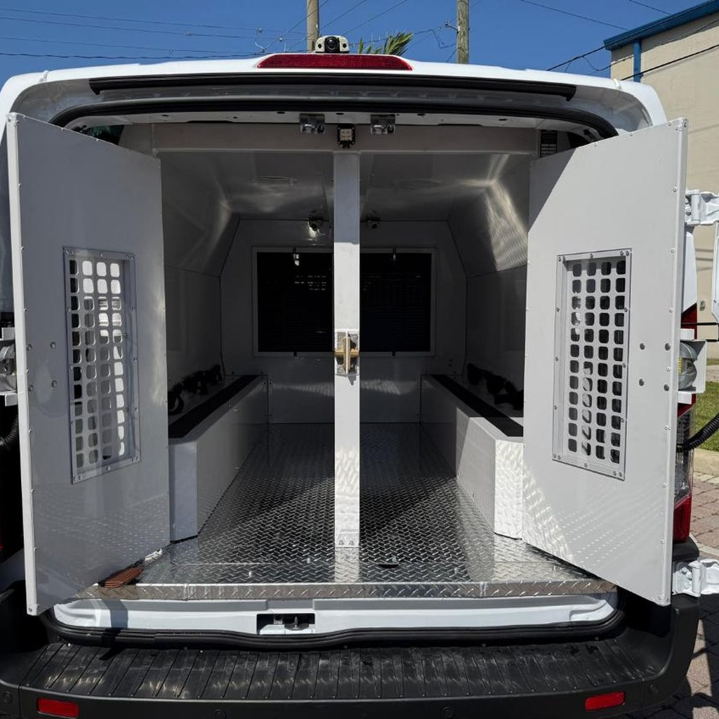 Prisoner transport van upfit with rear cell inserts and security doors