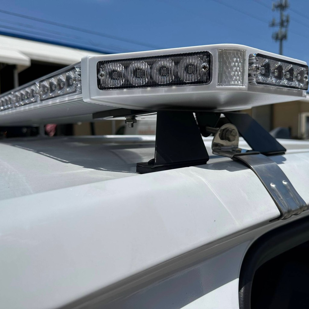 Close-up of a white roof-mounted LED light bar installed on a fleet pickup