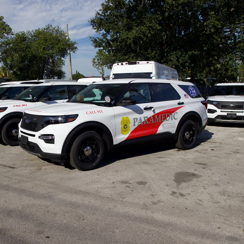Fleet of upfitted fire rescue paramedic Explorers with emergency lighting and graphics